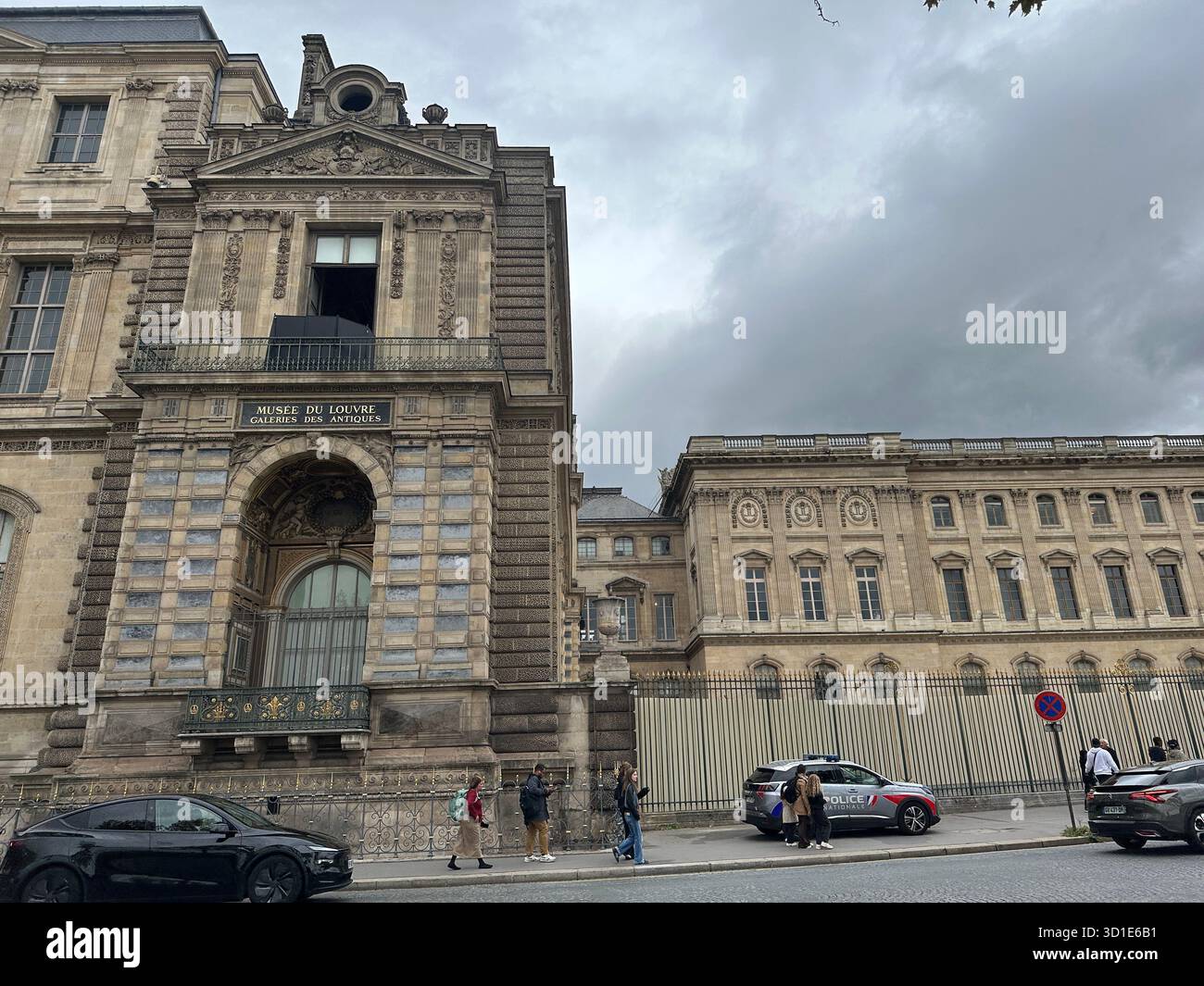 Louvre heist Paris 29 October 2025. Jewels robbery. Open window at historic facade. Street scene with tourists. Crime scene becomes tourist attraction - Smartphone Captured Stock Image