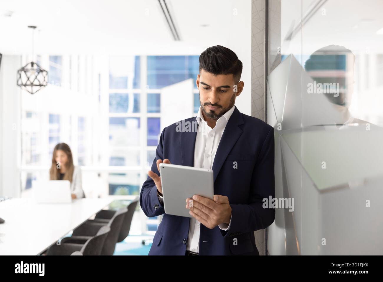 Focused busy Indian manager man using business application Stock Photo