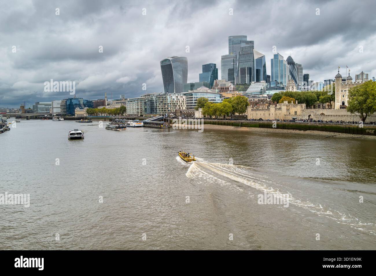 A view of the historic Tower of London with the iconic buildings of the City of London in the background in London in the UK. Stock Photo