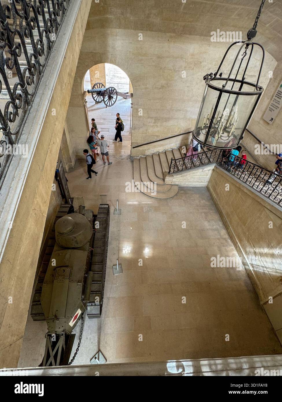 visitors walking inside the historic interior of les invalides in paris, france, the scene shows a large hall with staircases,overlooking a tank - Smartphone Captured Stock Image
