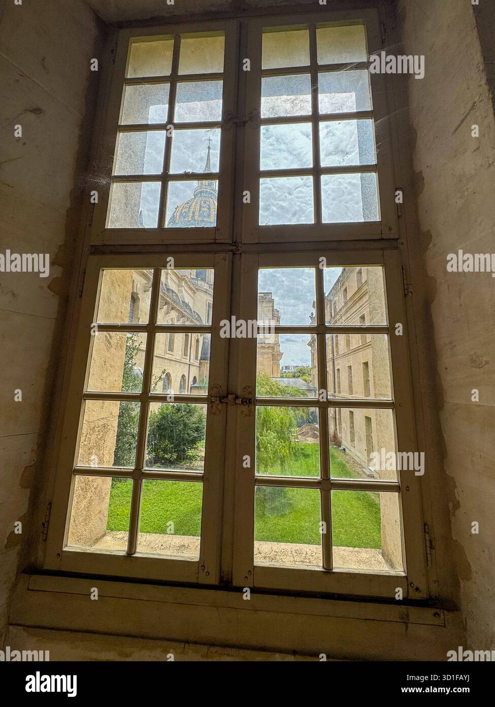 a unique perspective looking through a wooden window with spiderwebs. outside the famous golden dome of the hotel des invalides in paris - Smartphone Captured Stock Image