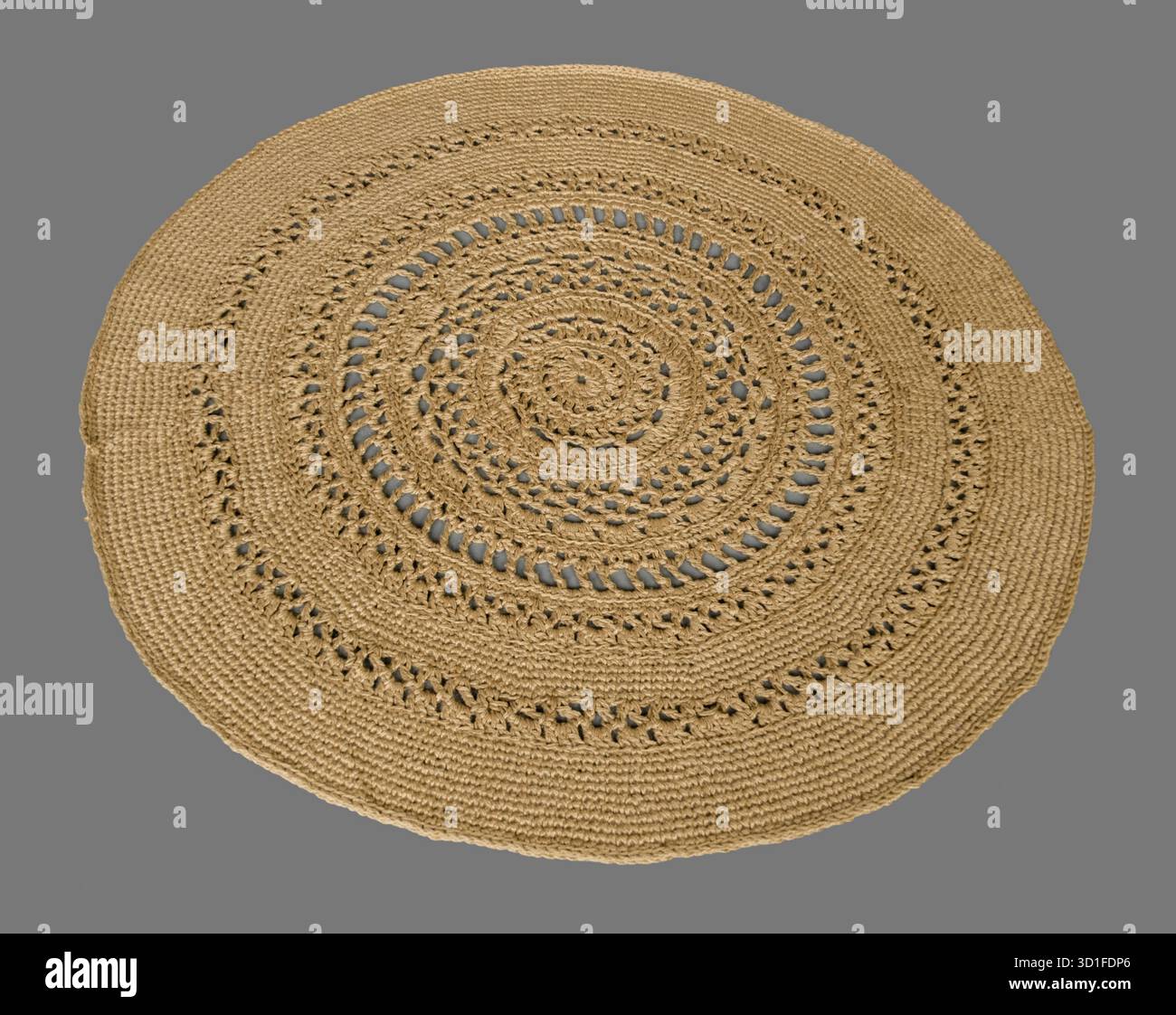 Round crocheted rug on a gray background Stock Photo