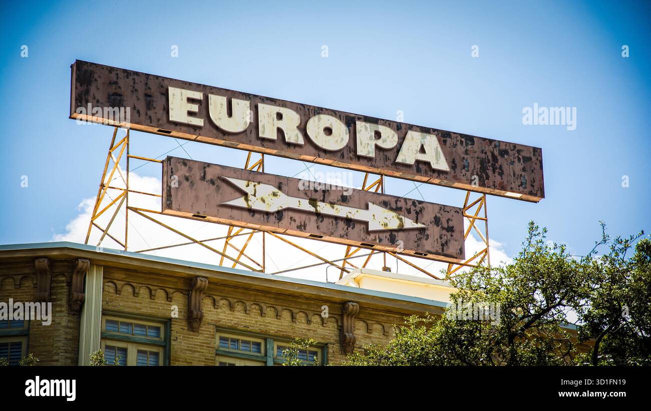 picture shows a signpost and a sign pointing towards Europe in German ...