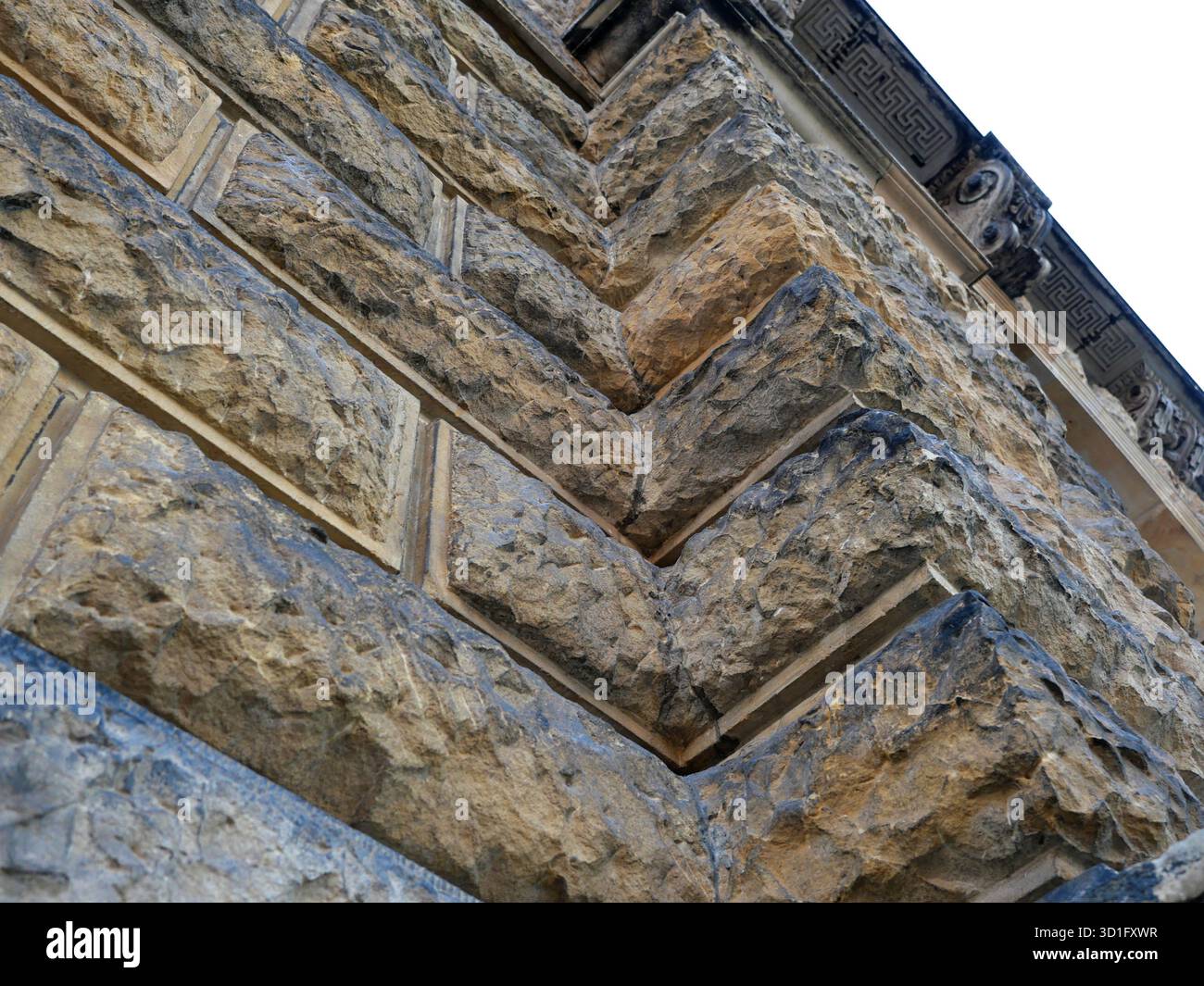 Historic rusticated stone wall with irregular, rough blocks. Close-up. Copyspace. Stock Photo
