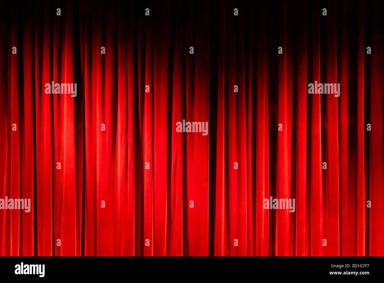 Deep red velvet curtain creating a performance stage background Stock Photo