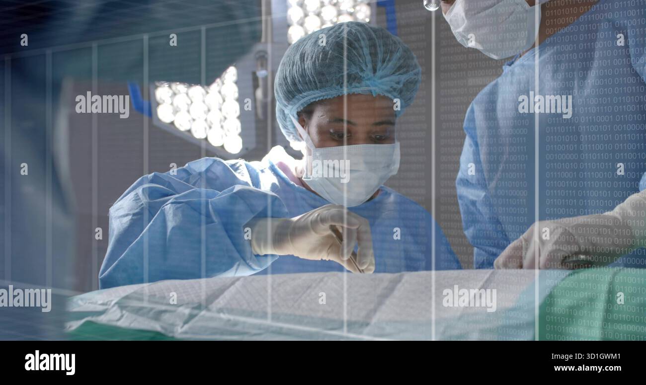 Mid adult surgeon in blue gown making incision in operating room, with ...