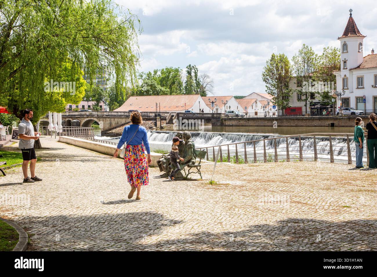 The Nabão River in the city of Tomar, Portugal. The river is a central feature of the city, with a riverside promenade and historic buildings Stock Photo