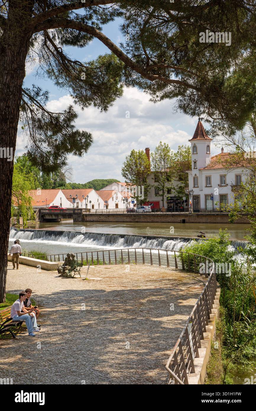 The Nabão River in the city of Tomar, Portugal. The river is a central feature of the city, with a riverside promenade and historic buildings Stock Photo