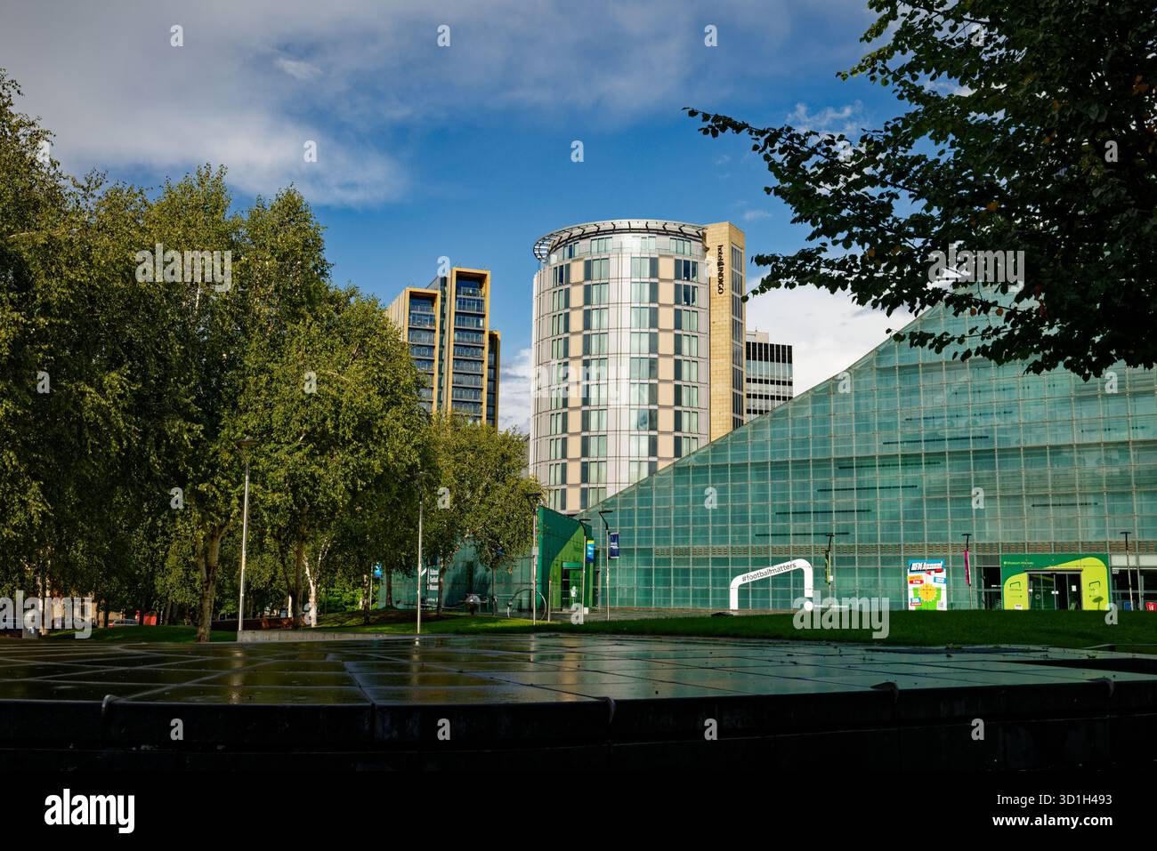 Tall buildings and the National Football Museum form a backdrop to Cathedral Gardens in Manchester city centre, England. Stock Photo