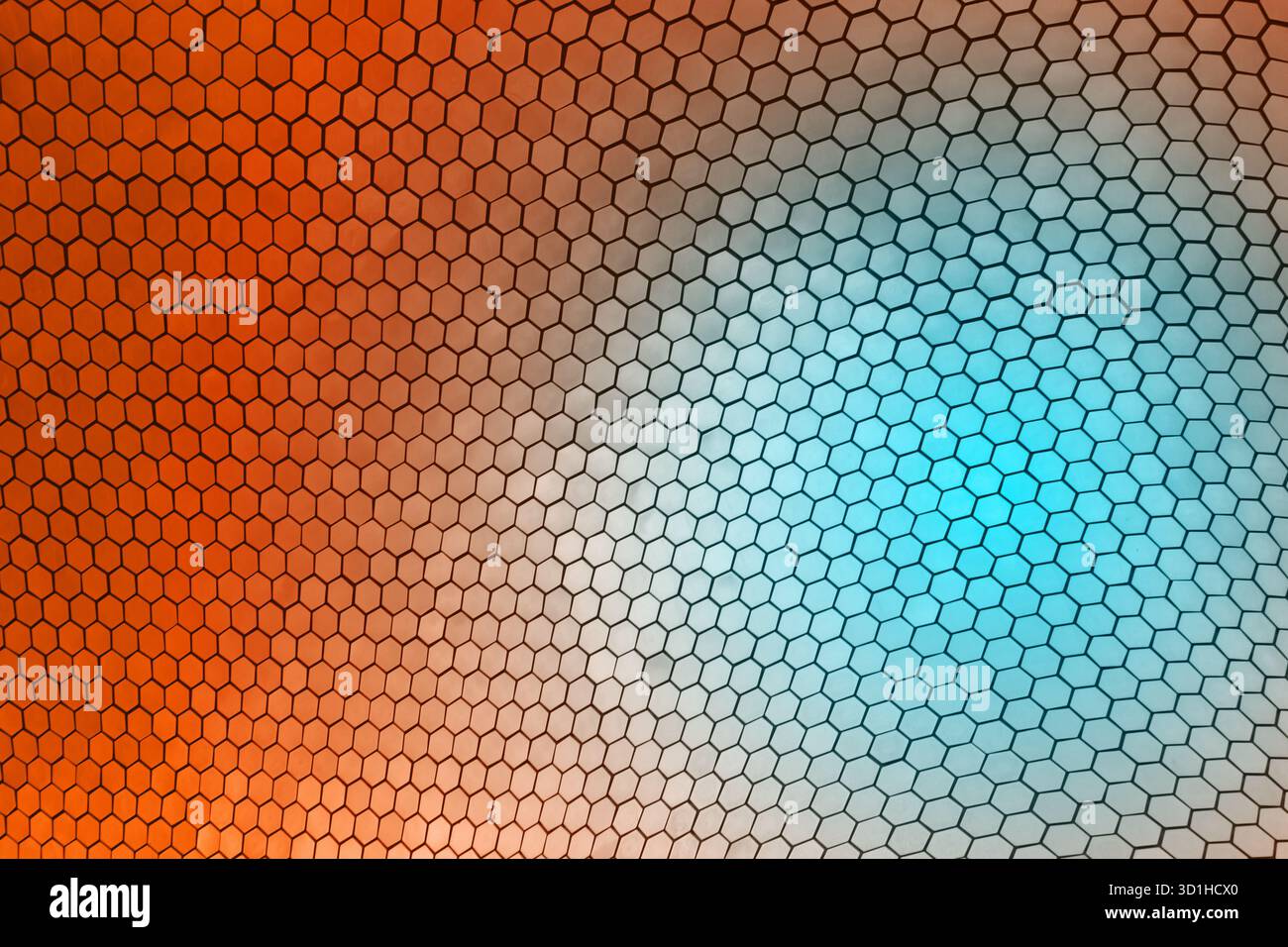 Geometric hexagonal pattern with orange and blue gradient light reflection on modern architectural surface, abstract minimal design background Stock Photo