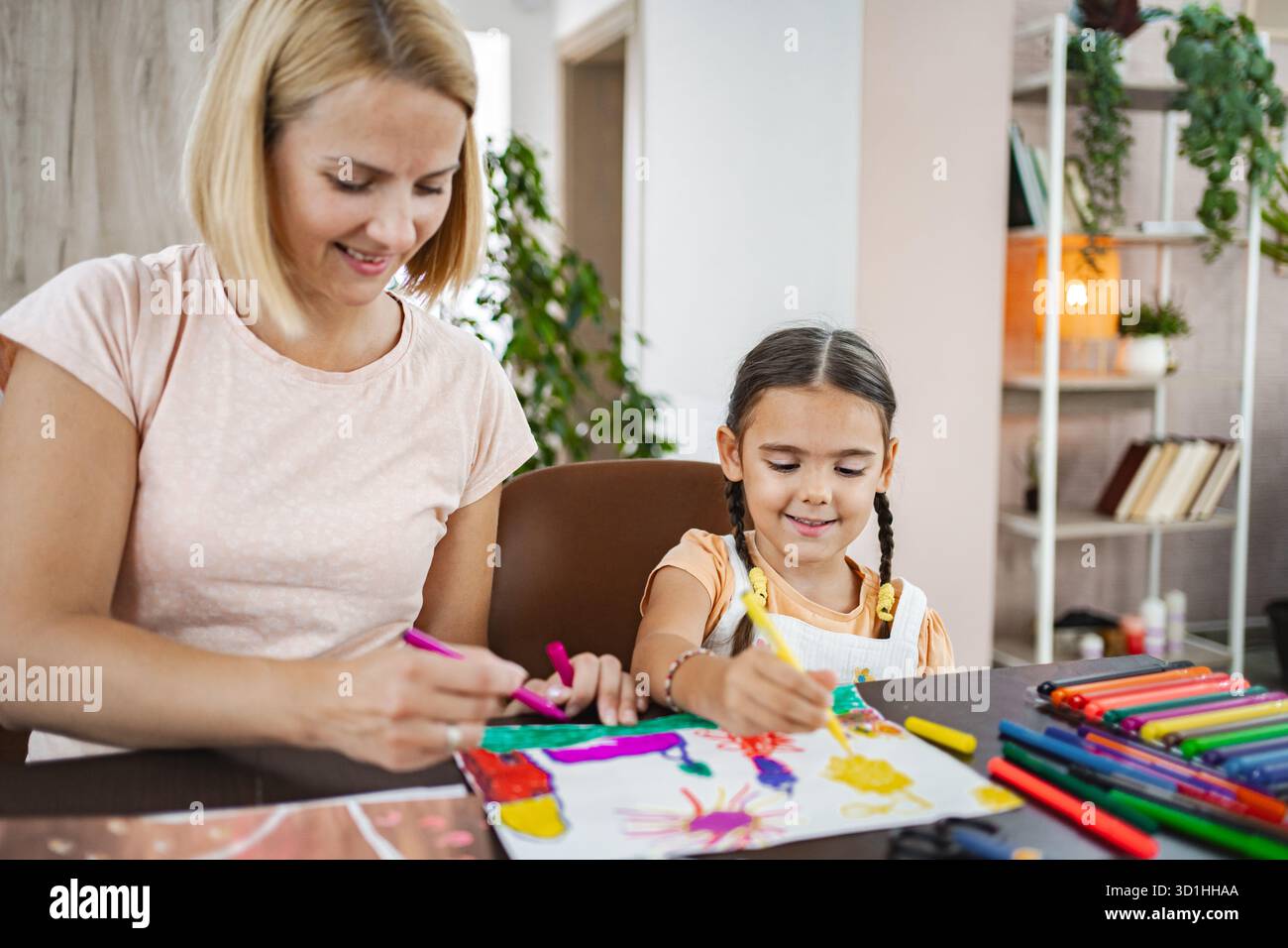 Mother and daughter enjoying a creative art session at home in the ...