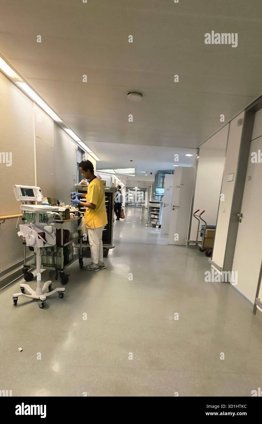 Belin, Germany - May 30, 2025: Male healthcare professional is preparing medical equipment in hospital corridor. Hospital - Smartphone Captured Stock Image