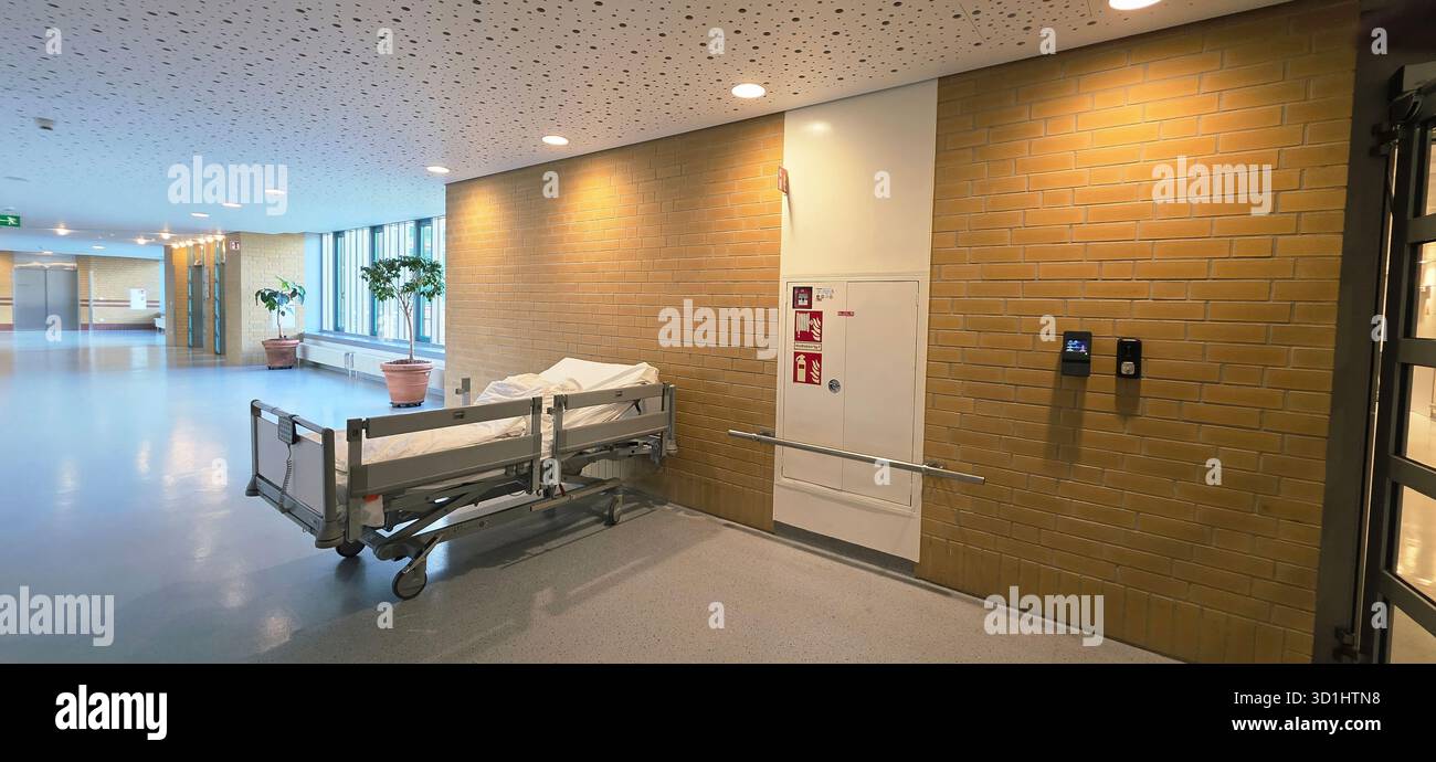 Belin, Germany - May 30, 2025: Hospital corridor features an empty patient bed and modern design elements throughout the space. Hospital - Smartphone Captured Stock Image