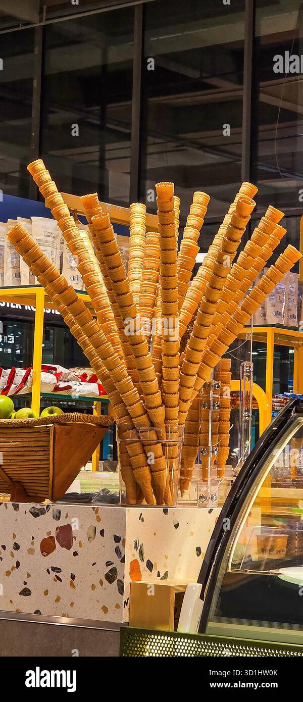 Doloman, Turkey - April 25, 2025: Ice cream cones are beautifully arranged in a display at a contemporary dessert shop. - Smartphone Captured Stock Image