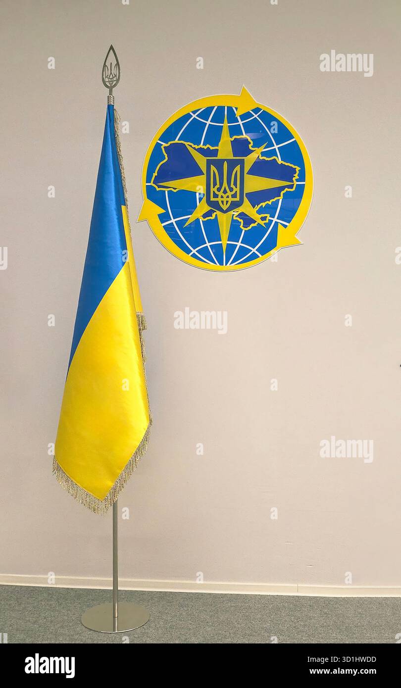 Belin, Germany - May 19, 2025: Ukrainian flag stands proudly beside the national emblem in an official office. - Smartphone Captured Stock Image