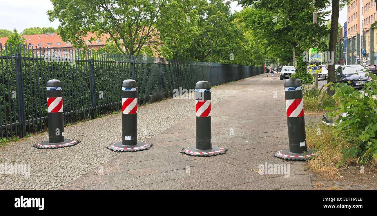 Belin, Germany - May 19, 2025: Traffic safety bollards are positioned along a pedestrian walkway in an urban environment. - Smartphone Captured Stock Image