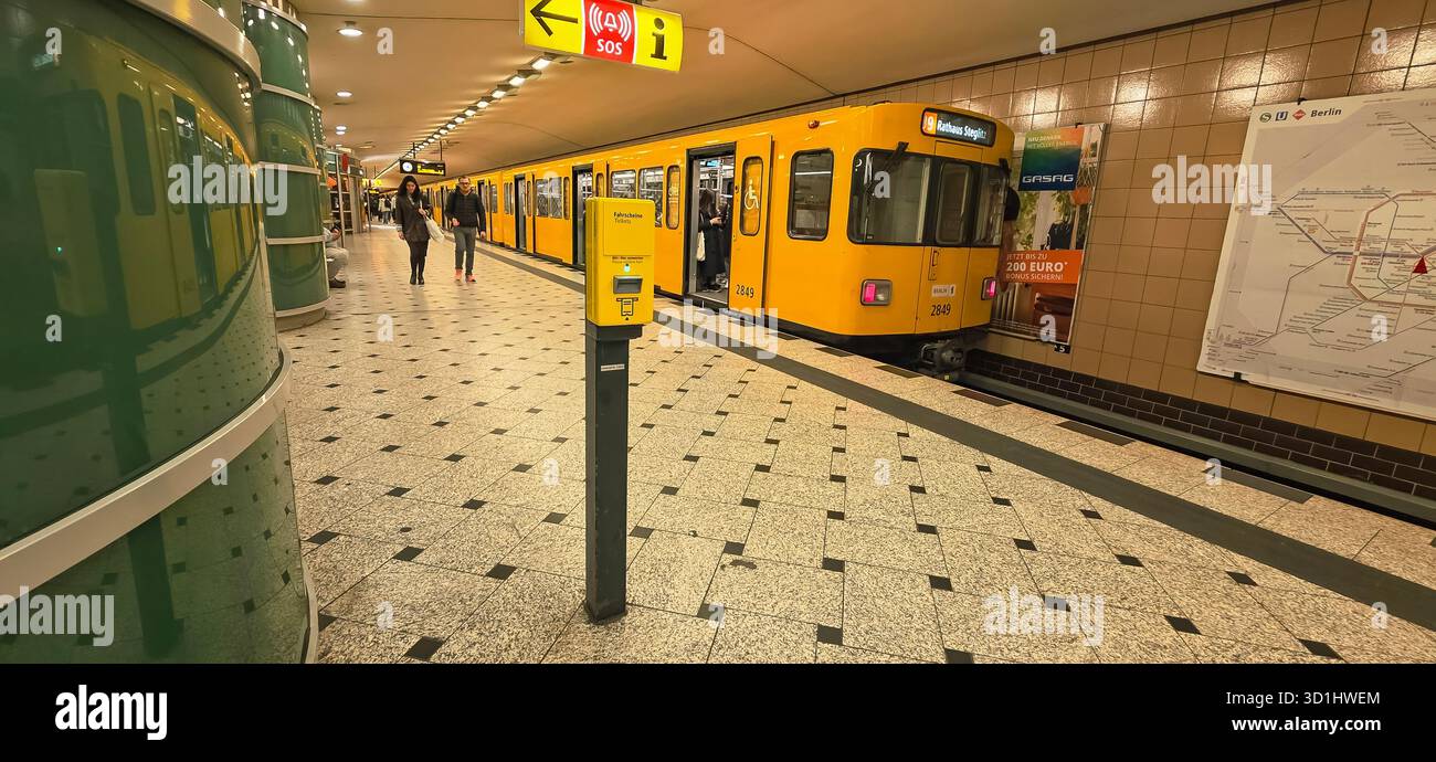 Belin, Germany - May 19, 2025: Yellow subway train is arriving at station as passengers walk along platform. - Smartphone Captured Stock Image