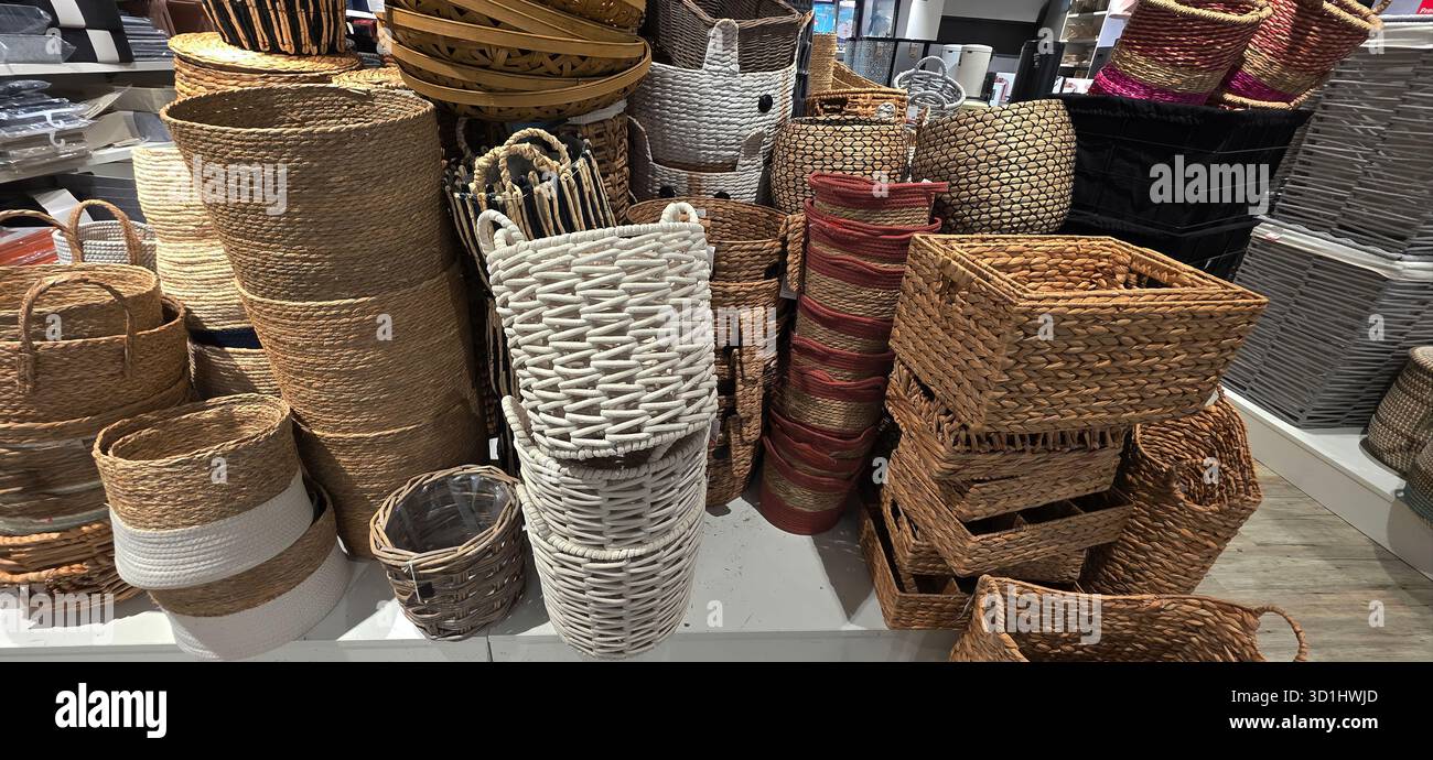 Assorted woven baskets of different shapes and sizes are displayed for sale, showcasing natural materials and intricate craftsmanship. - Smartphone Captured Stock Image