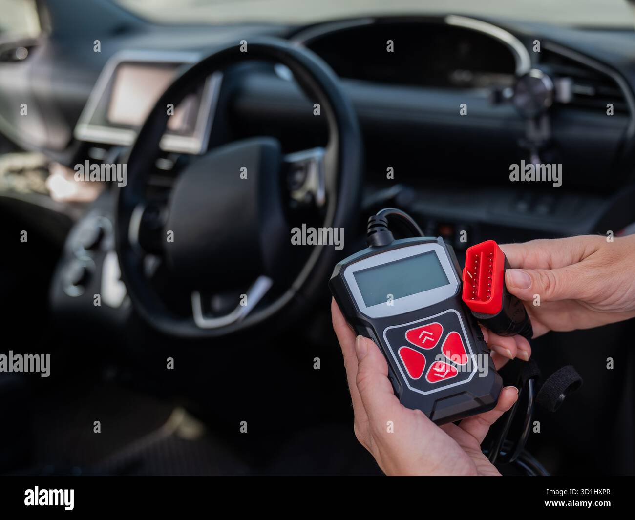 Woman using OBD2 diagnostic scanner.  Stock Photo