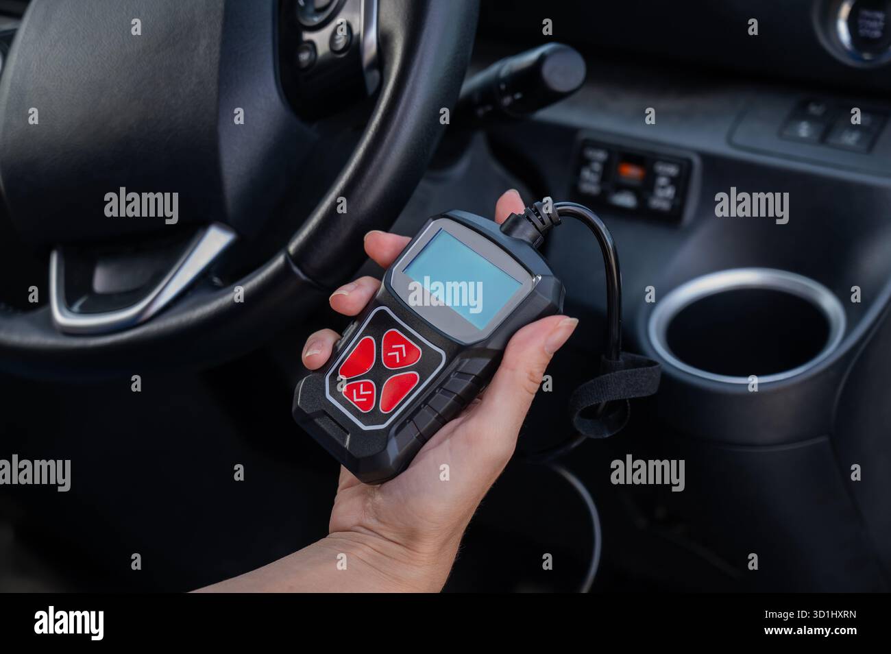 Woman using OBD2 diagnostic scanner.  Stock Photo