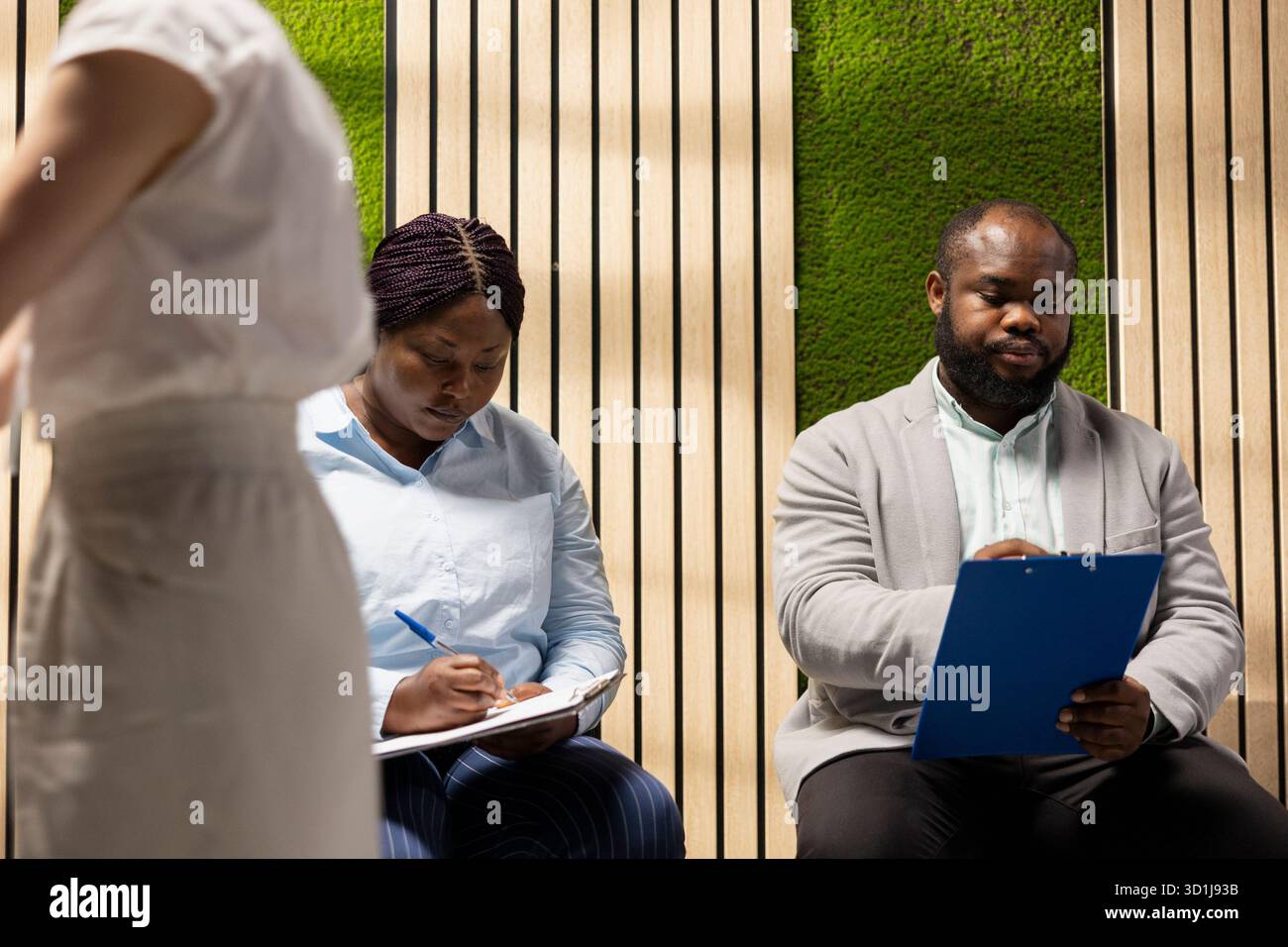 Candidates in the hallway giving CV resumes to HR secretary with a ...