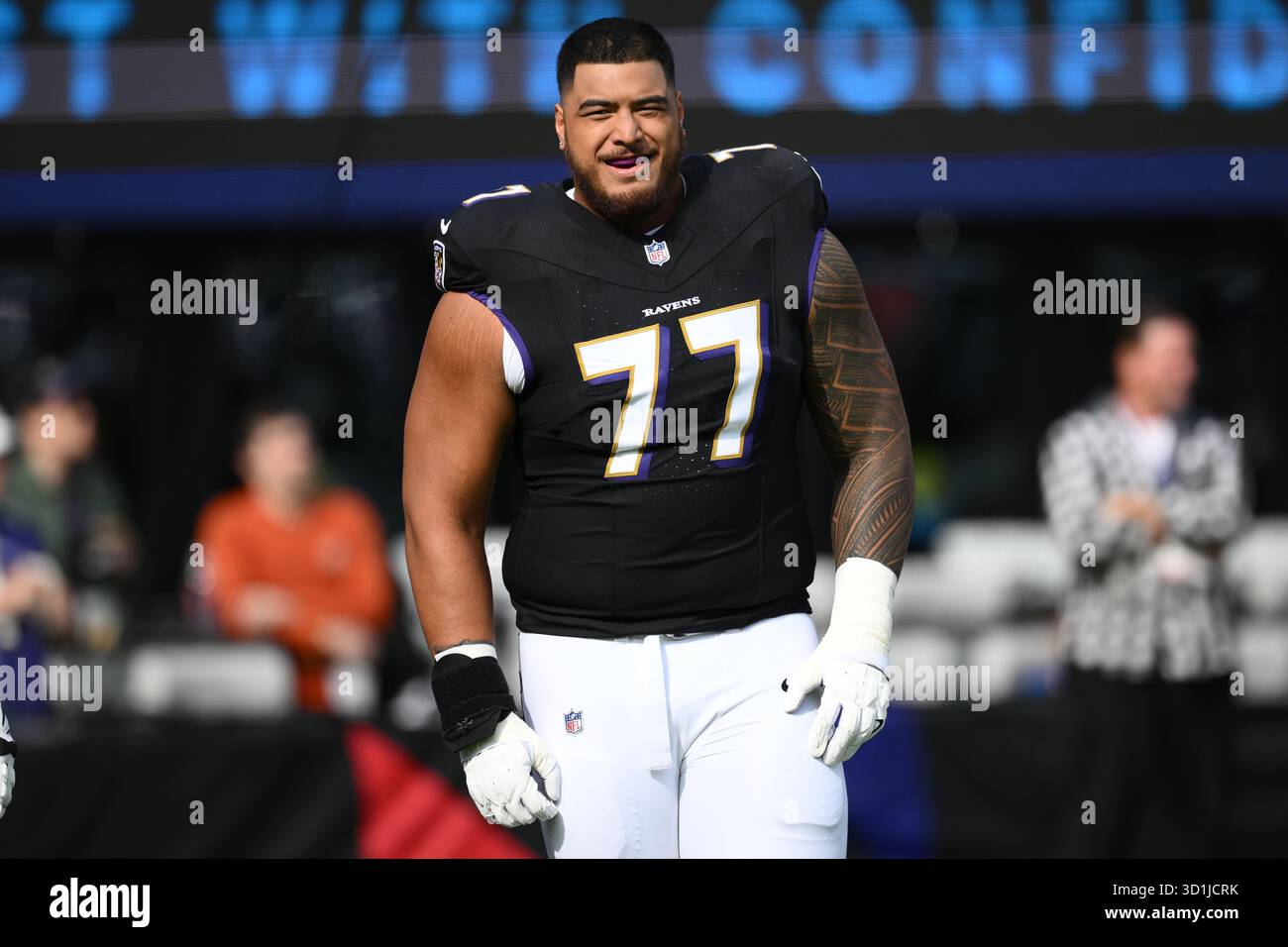 Baltimore Ravens guard Daniel Faalele (77) warms up before an NFL ...