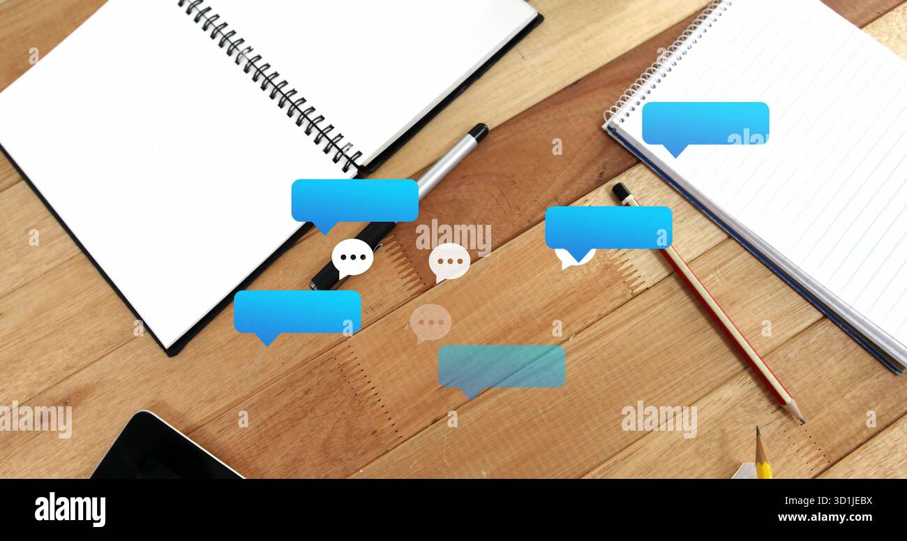 Displaying digital speech bubble icons floating above desk, with ...