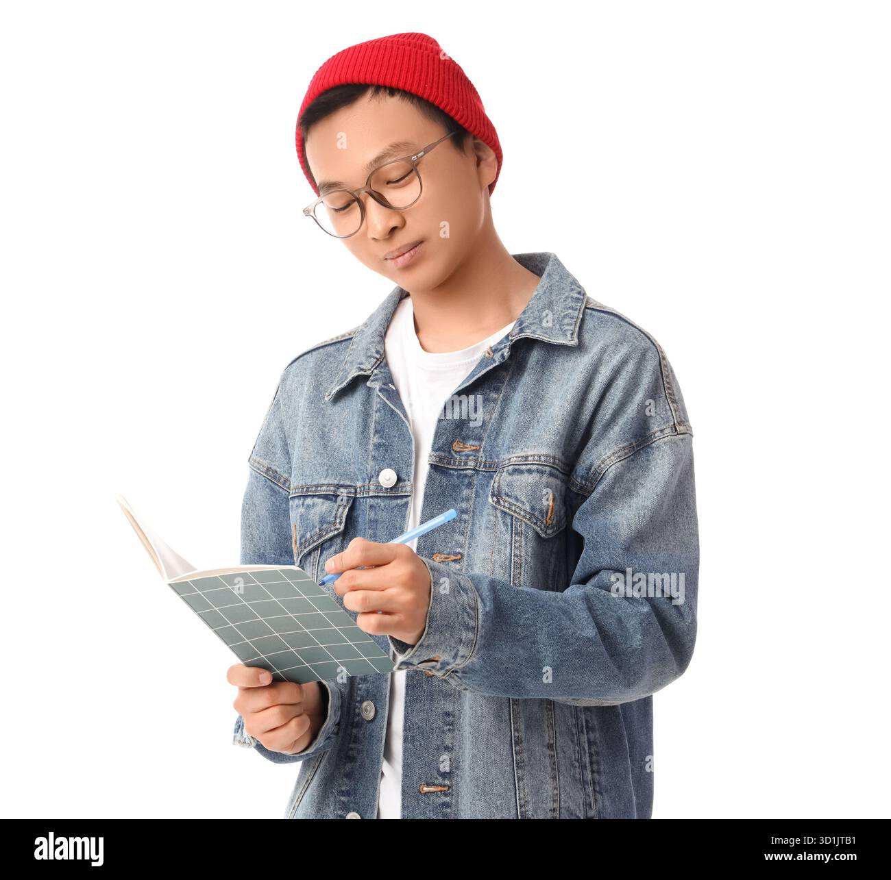 Young Asian man writing something in notebook on white background Stock Photo