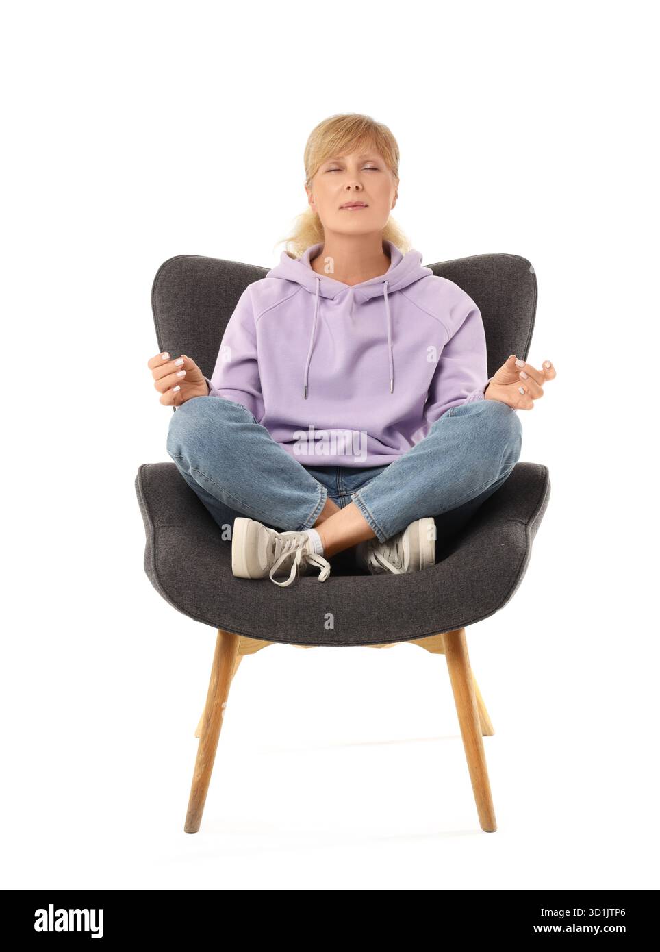 Mature woman meditating in armchair on white background Stock Photo - Alamy