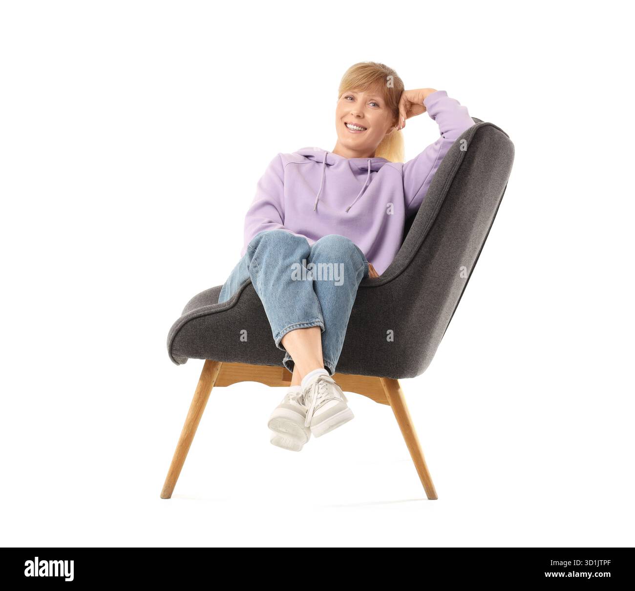 Mature woman sitting in armchair on white background Stock Photo - Alamy