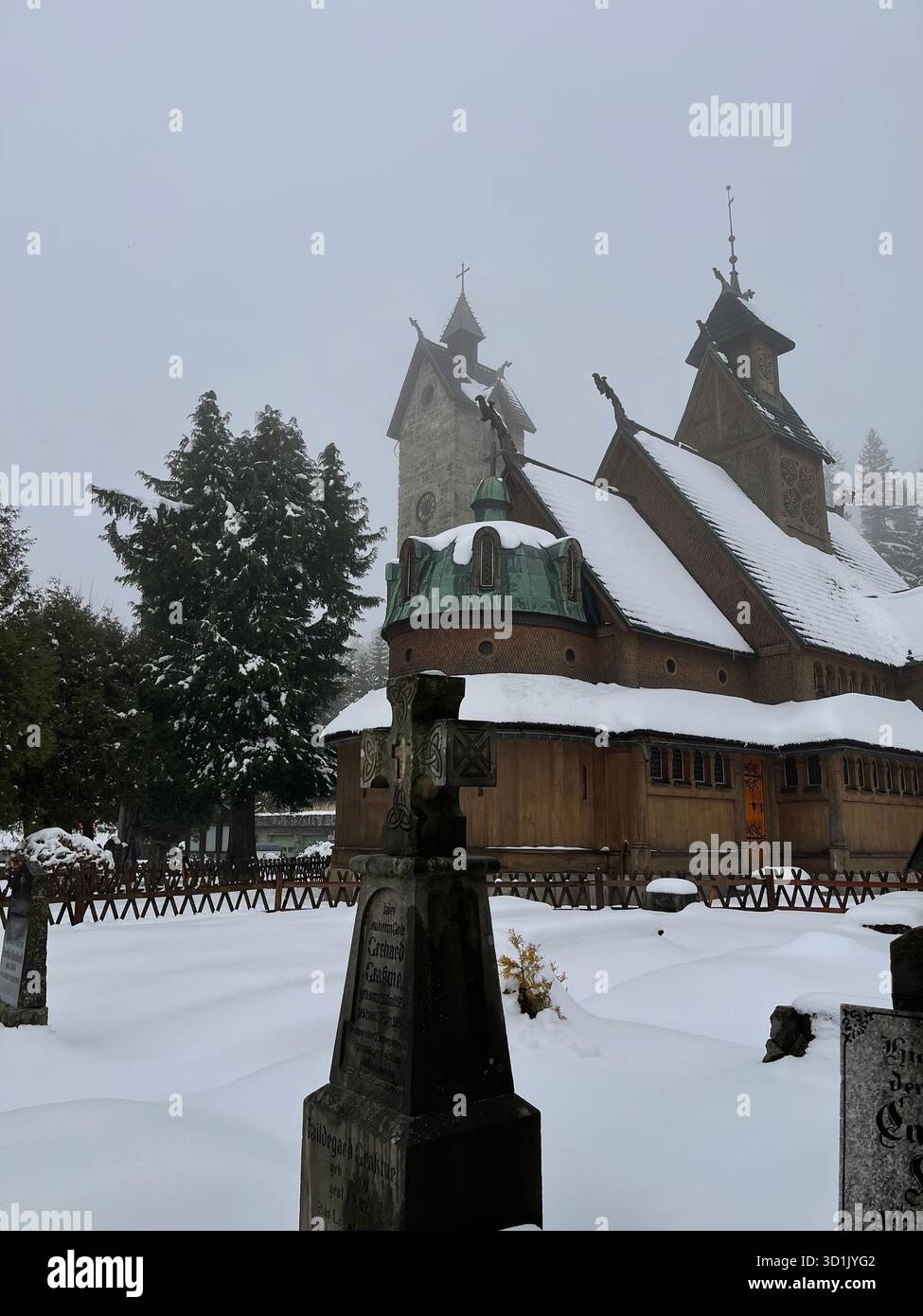 Snow-covered statue of Jesus Christ located in the historic cemetery area near Wang Church in Karpacz, Poland. A winter landscape - Smartphone Captured Stock Image
