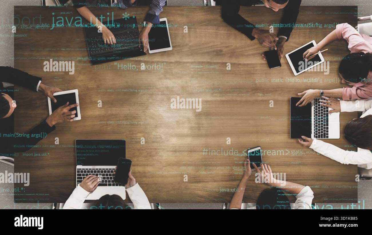 A modern office setting featuring a diverse team engaged in collaborative discussions, utilizing laptops and tablets for coding and innovative ideas Stock Photo
