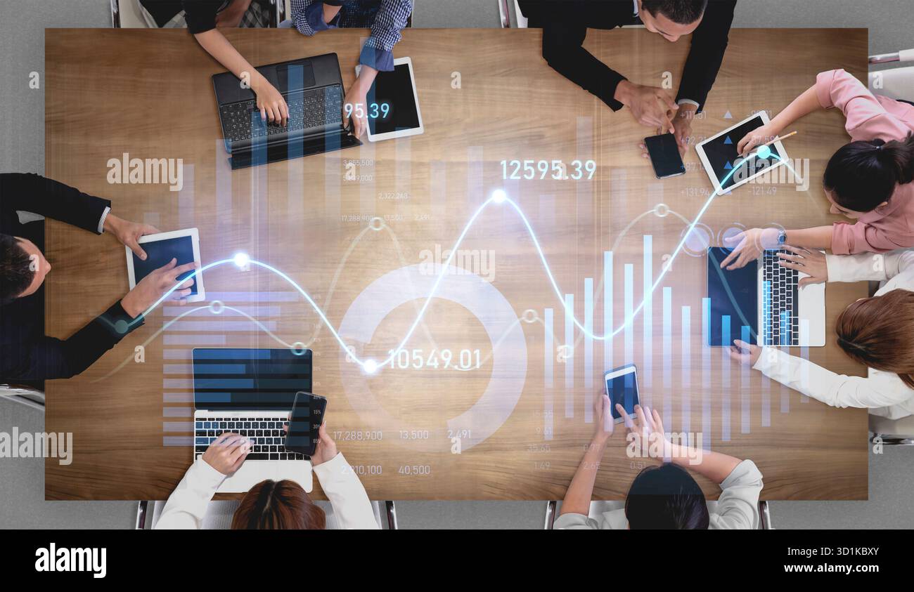 A diverse business team collaborates at a modern office table ...