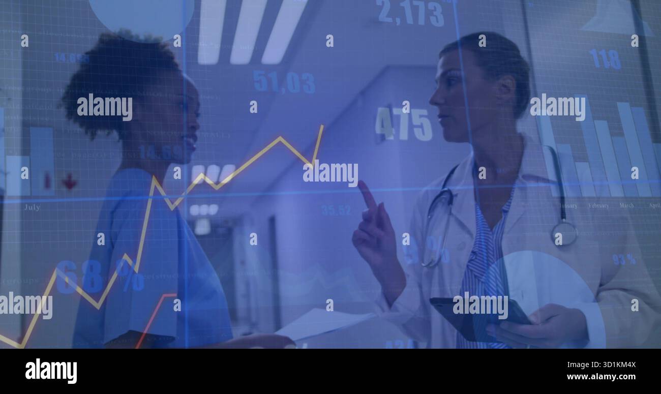 Nurse in scrubs and lab-coated doctor examining chart and tablet in ...
