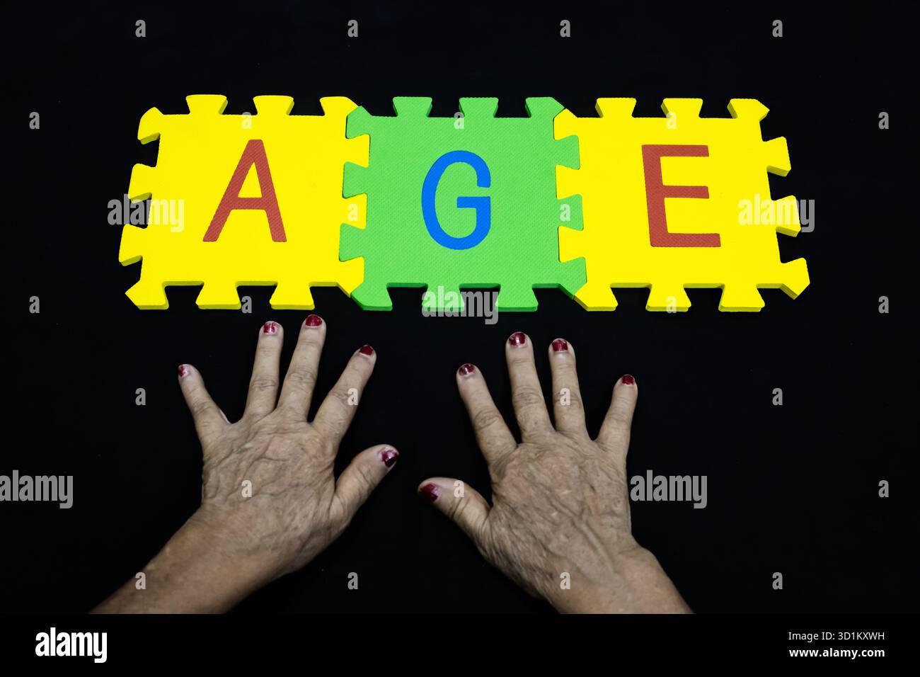 Ageing Lettering concept of aging or elder years presented with wrinkled hands and ...