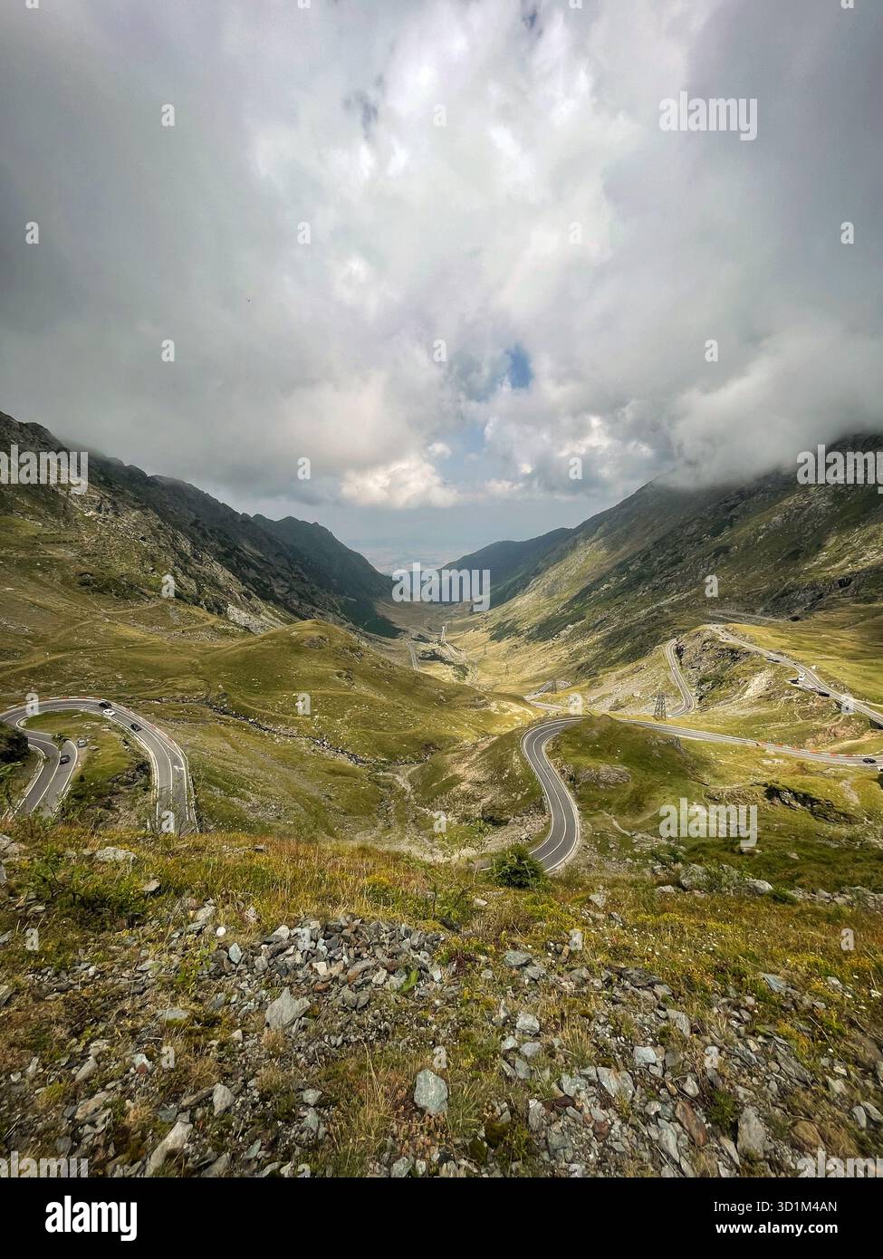 Long empty road through mountains representing journey, exploration, and the path ahead. - Smartphone Captured Stock Image
