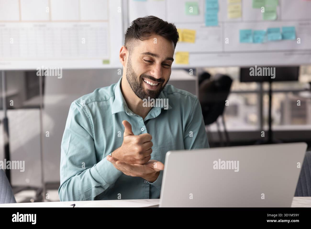 Friendly young businessman consult client by videocall using hand gestures Stock Photo