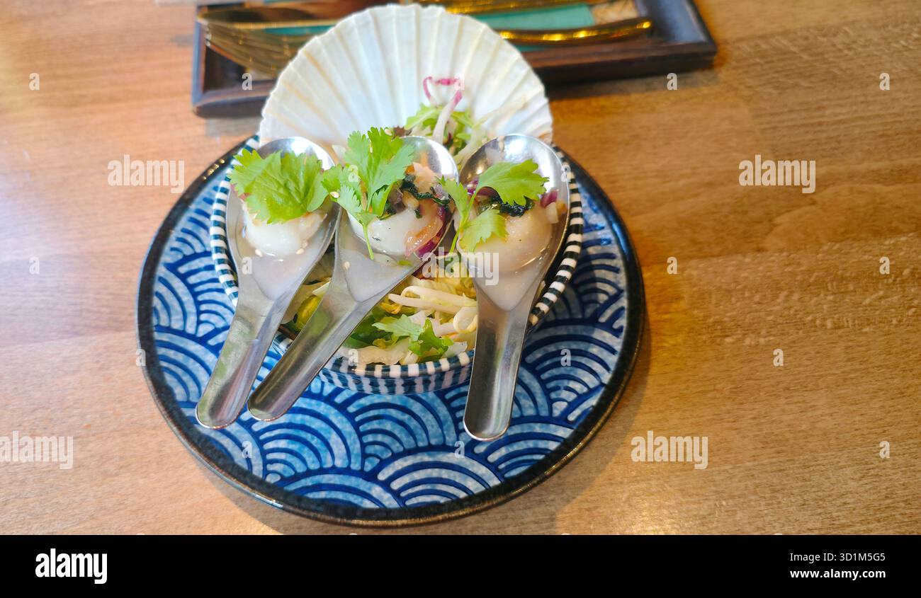 Elegant appetizer served in spoons on a decorative plate, garnished with fresh herbs, showcasing culinary artistry and vibrant colors. - Smartphone Captured Stock Image