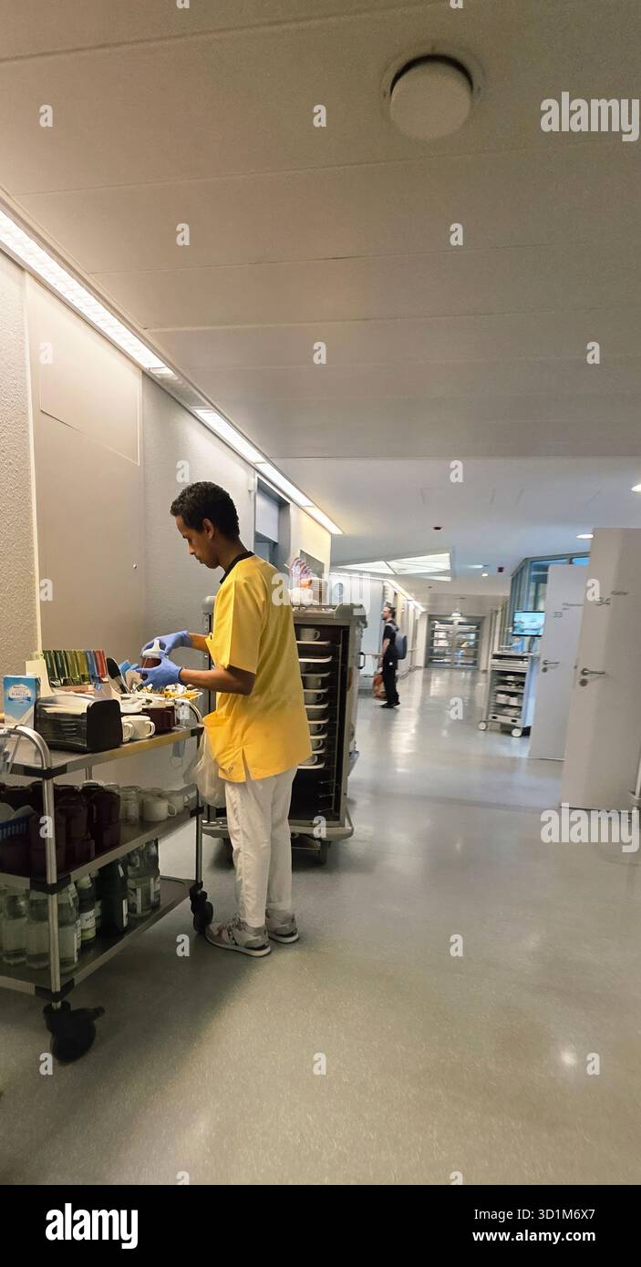 Belin, Germany - May 30, 2025: Male healthcare professional is organizing medical supplies in hospital corridor. Hospital - Smartphone Captured Stock Image