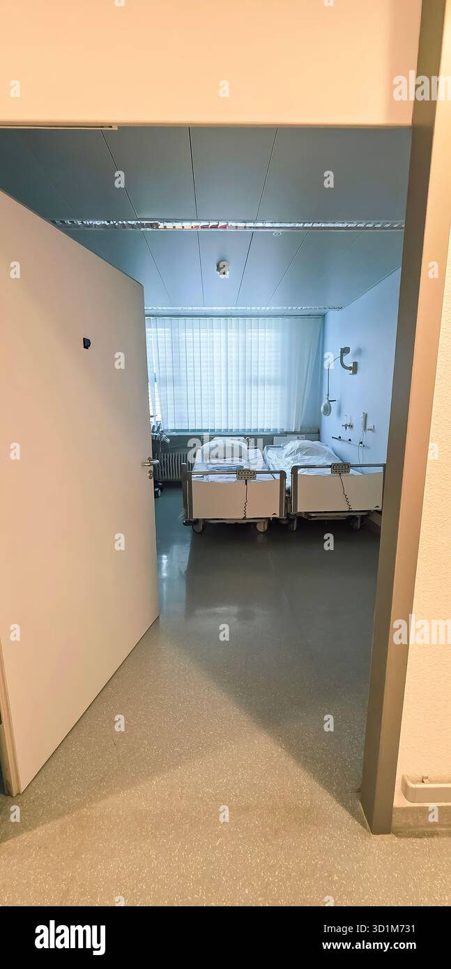 Belin, Germany - May 30, 2025: Entrance to a hospital room featuring two beds and bright natural light illuminating the space. Hospital - Smartphone Captured Stock Image
