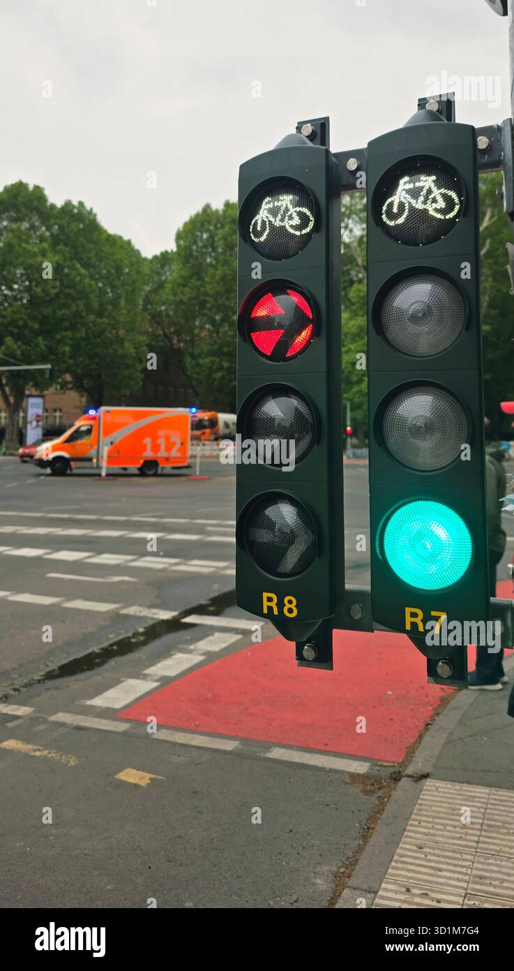 Belin, Germany - May 19, 2025: Traffic light shows green signal for bicycles at busy urban intersection with vehicles. - Smartphone Captured Stock Image