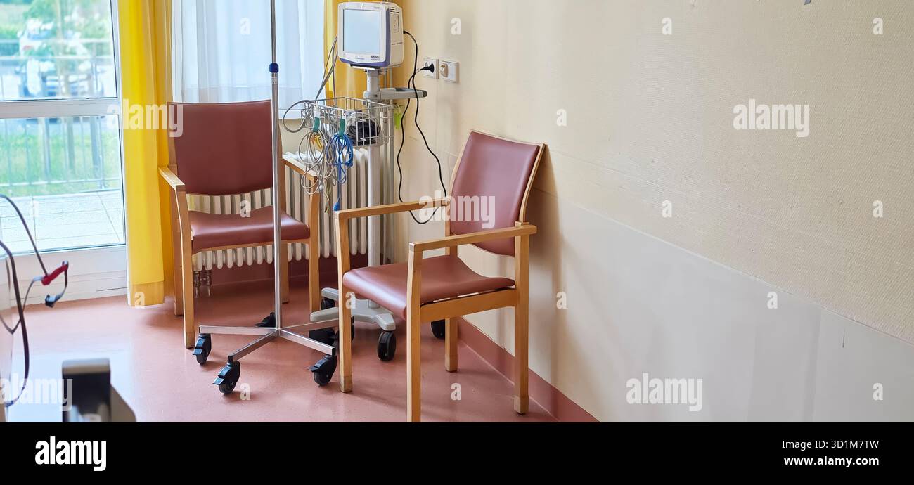 Berlin, Germany - June 16, 2025: Hospital room features empty chairs and medical equipment in a bright environment. - Smartphone Captured Stock Image