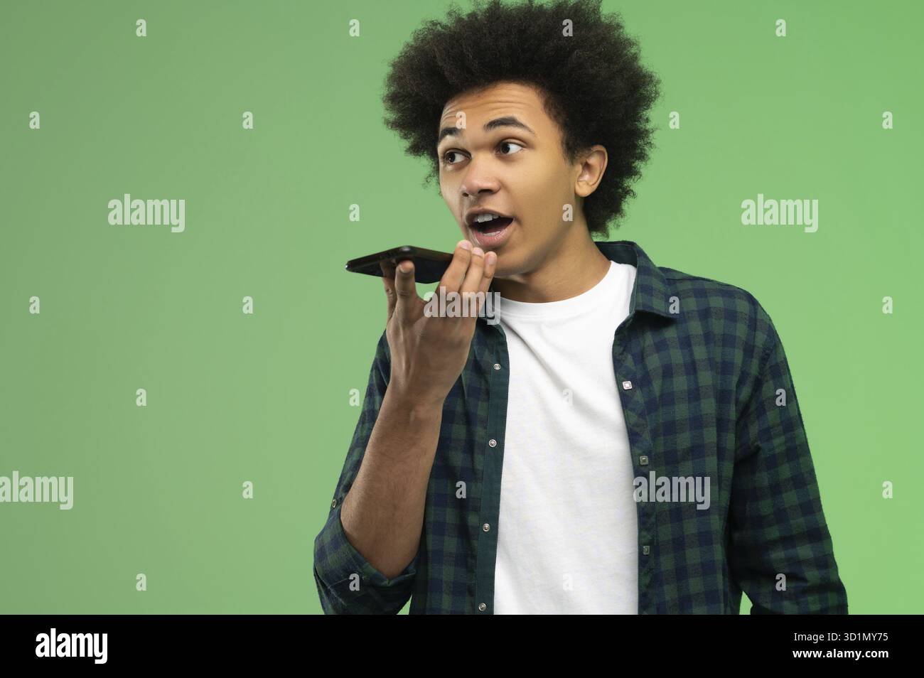 Voice message. Young african american recording a voice message Stock Photo