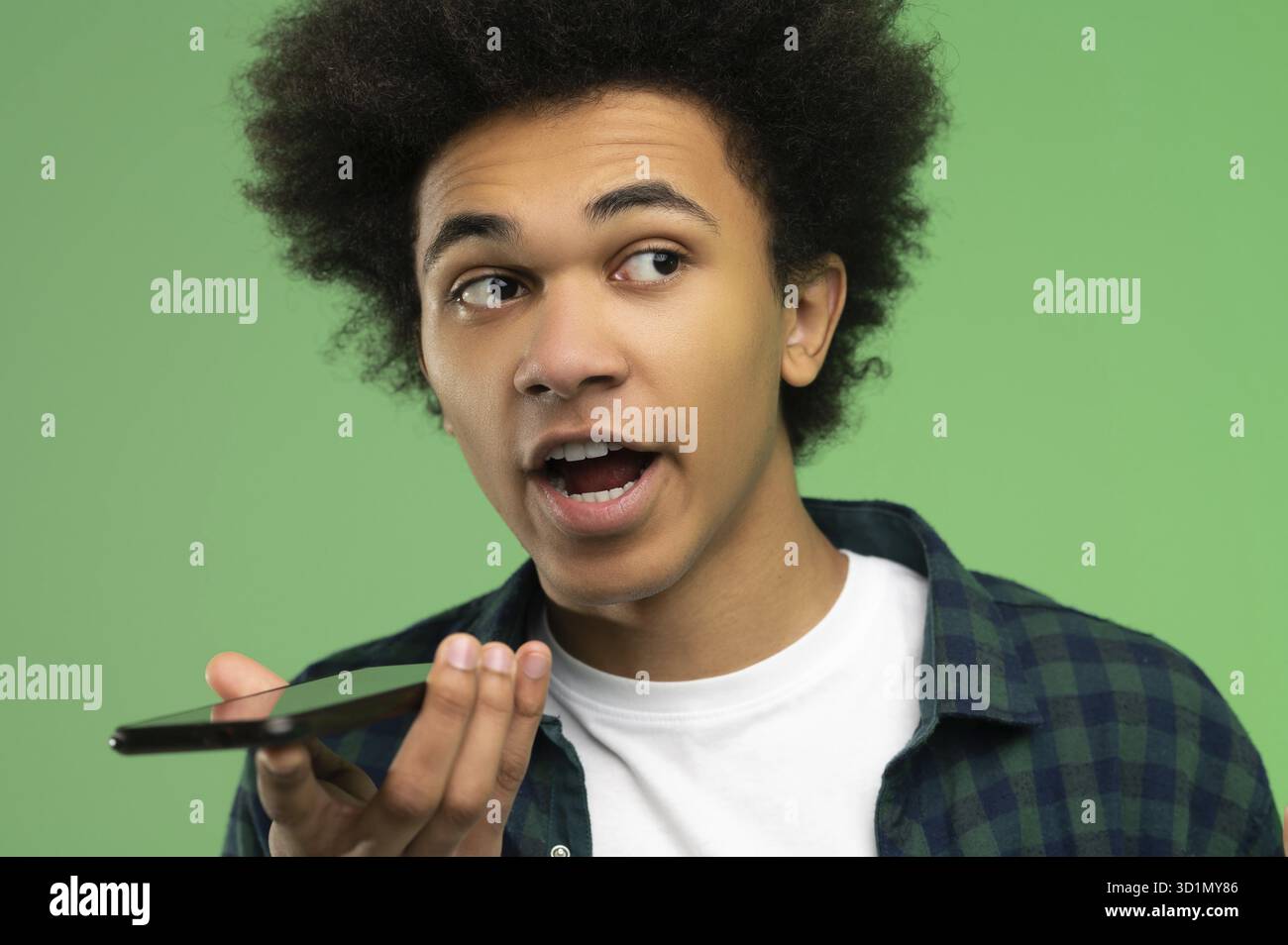 Voice message. Young african american recording a voice message Stock Photo