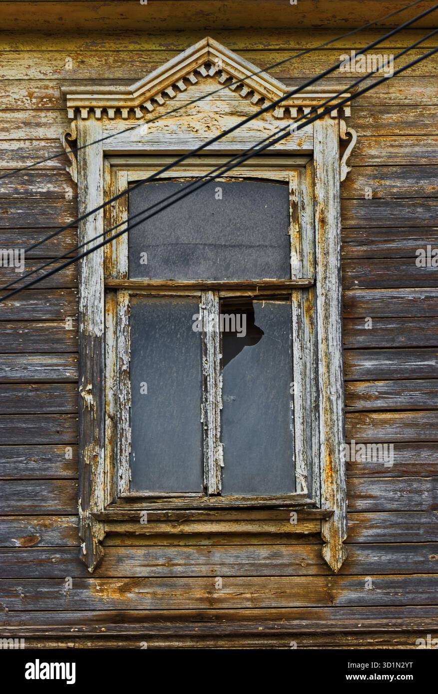 Weathered wooden window in slums with broken glass Stock Photo