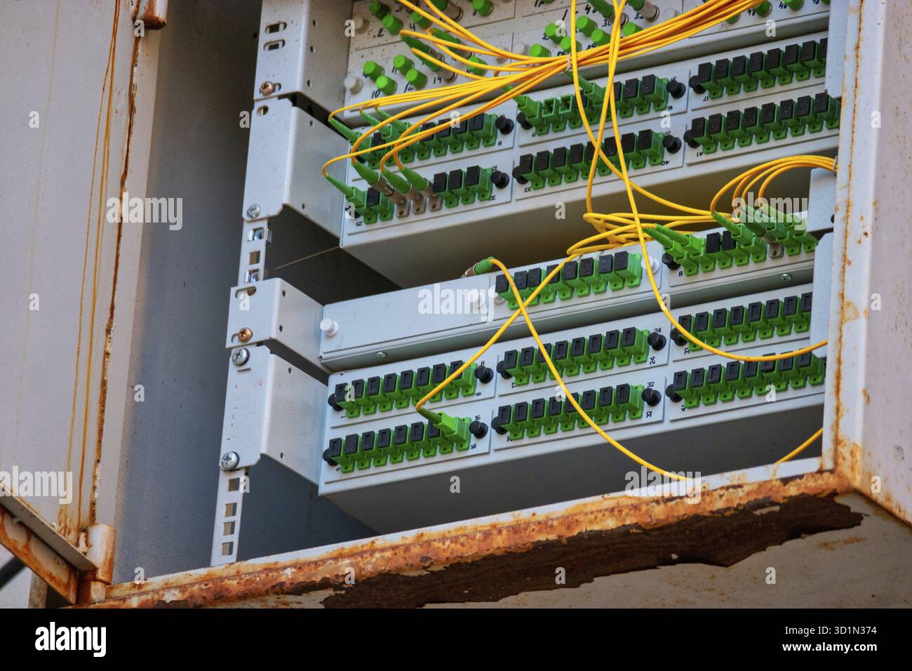 Open box with patch-panels with many fiber optic cords connected into Stock Photo