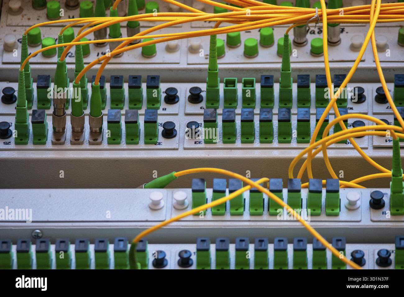 Fiber optic Patch Panel Open With Some Patch Cords Connected Stock Photo