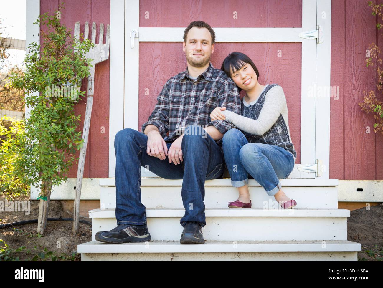 Mixed Race Couple Relaxing on the Steps Stock Photo
