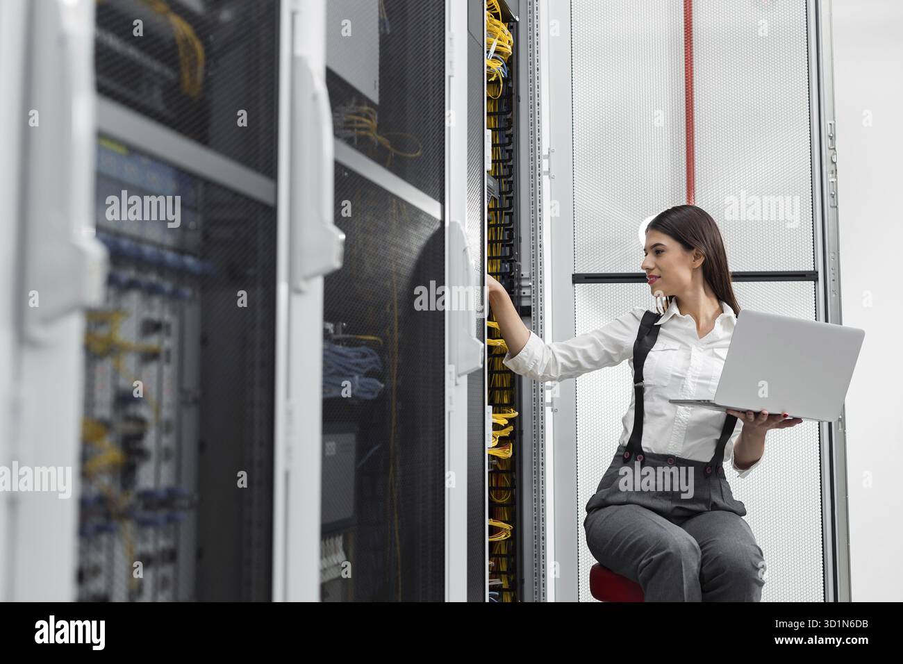 Technician examining server in server room Stock Photo