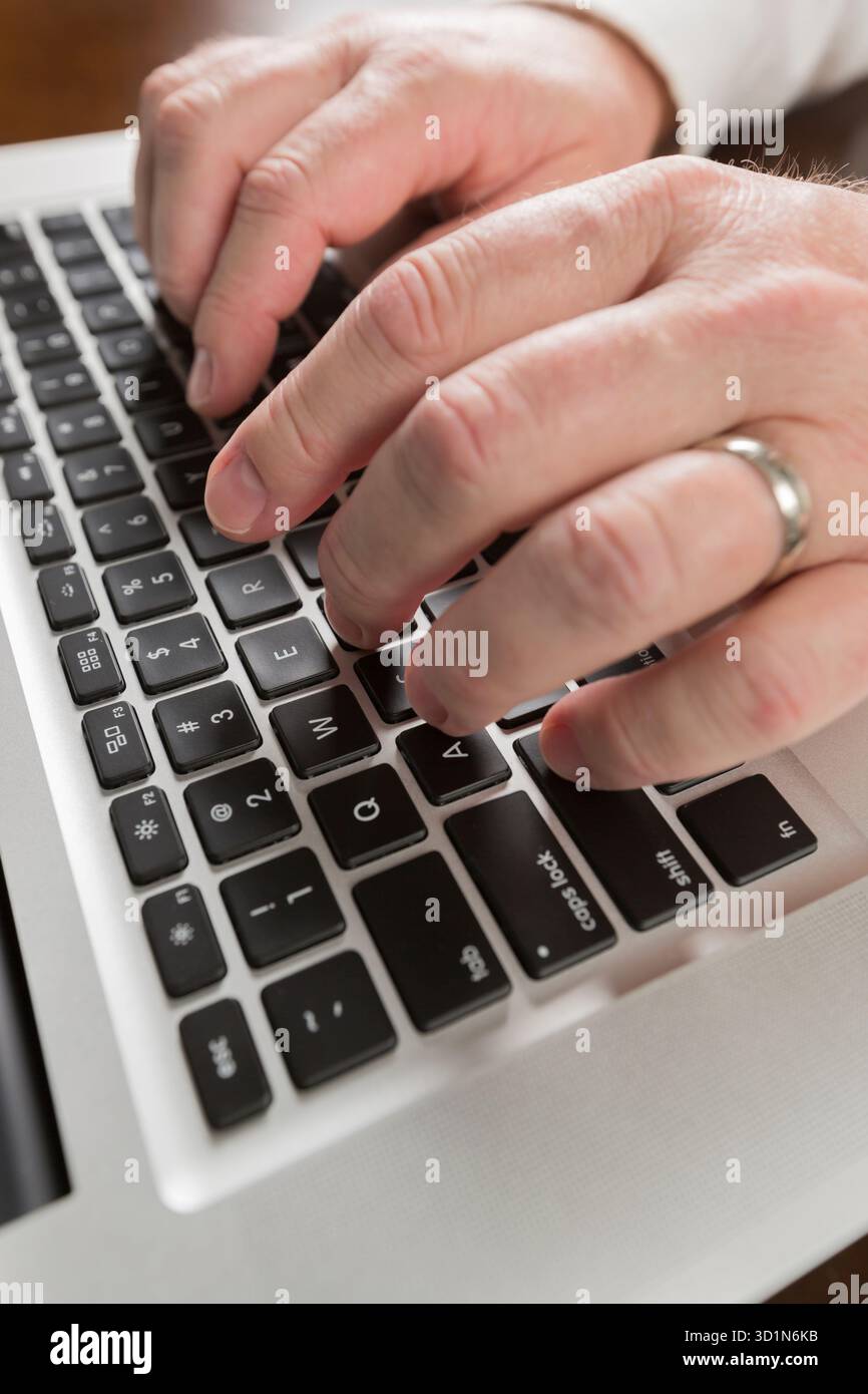 Male Hands Typing on Laptop Computer Stock Photo